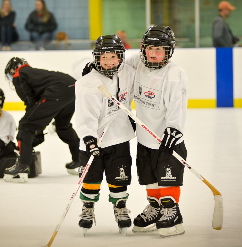 two young hockey players arms around each other